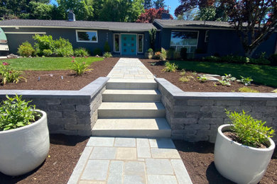 Design ideas for a mid-sized contemporary front yard stone formal garden in Portland.