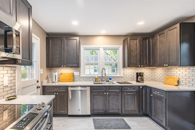 Inspiration for a mid-sized modern kitchen remodel in Other with an undermount sink, shaker cabinets, gray cabinets, quartz countertops, white backsplash and glass tile backsplash