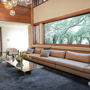 Diseño de salón para visitas abierto, actual, de tamaño medio, sin televisor, con paredes blancas, suelo de pizarra, estufa de leña, marco de chimenea de ladrillo y suelo gris