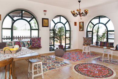 Mediterranean living room in Other with white walls.