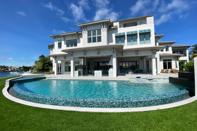 Pool - large modern backyard stone and round pool idea in Miami