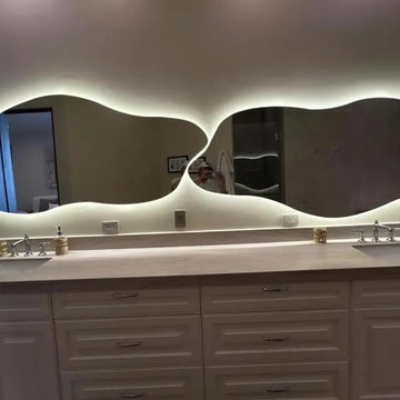 Backlit Wave-Edge Mirror Pair Over a Double Vanity