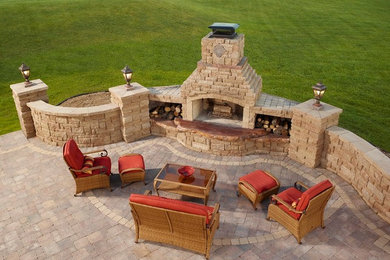 Large traditional patio in Minneapolis with a fire feature and concrete pavers.
