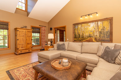 Inspiration for a large rustic formal and enclosed light wood floor and brown floor living room remodel in Chicago with beige walls, a standard fireplace, a brick fireplace and no tv