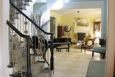 Mid-sized elegant wooden curved staircase photo in Other with painted risers
