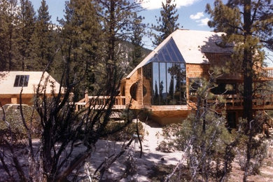 Example of a large trendy two-story wood exterior home design in Other