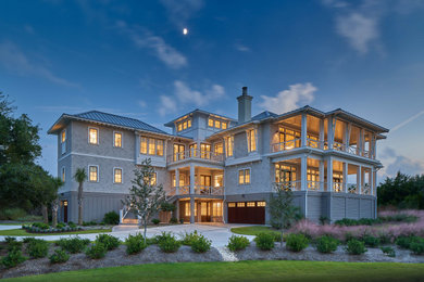 Example of a huge beach style beige three-story wood and shingle house exterior design in Other with a metal roof and a gray roof