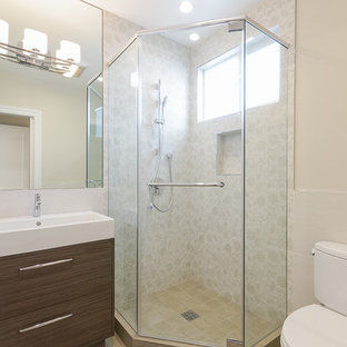 Inspiration for a small modern shower room in San Francisco with an integrated sink, flat-panel cabinets, medium wood cabinets, solid surface worktops, a corner shower, a two-piece toilet, beige tiles, beige walls and a hinged door.