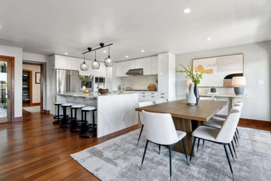 Example of a large dark wood floor and brown floor kitchen/dining room combo design in Los Angeles with white walls