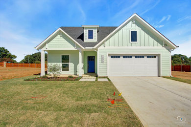 Example of a farmhouse green one-story concrete fiberboard house exterior design in Dallas with a shingle roof