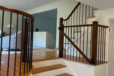 Inspiration for a mid-sized contemporary wooden straight mixed material railing staircase remodel in New York with wooden risers