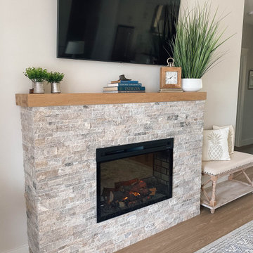 Light Stone Fireplace with a Wood Mantle