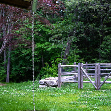 Cedar split rail fence and rain chain at Red Barn, Red Brick