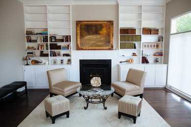 Family room - large transitional dark wood floor and brown floor family room idea in Detroit with beige walls, a standard fireplace, a wood fireplace surround and no tv