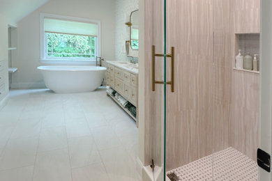 Large beach style master porcelain tile, white floor, double-sink, vaulted ceiling and wallpaper bathroom photo in Boston with recessed-panel cabinets, light wood cabinets, a one-piece toilet, white walls, an undermount sink, a hinged shower door, white countertops, a niche and a freestanding vanity