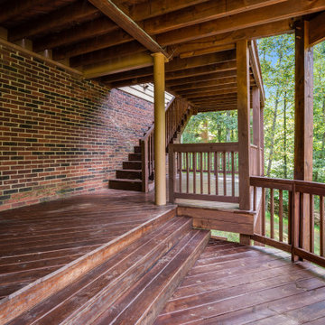 Tiered Backyard Deck with Brick Accent and Stained Wood Finish