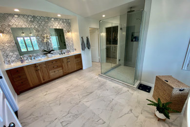 Bathroom - large modern master multicolored tile and porcelain tile porcelain tile, multicolored floor and double-sink bathroom idea in Los Angeles with recessed-panel cabinets, light wood cabinets, a one-piece toilet, gray walls, quartzite countertops, white countertops and a freestanding vanity