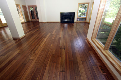 Trendy medium tone wood floor living room photo in Boise with a standard fireplace and white walls