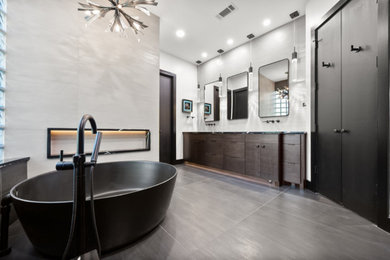 Bathroom - large modern master gray tile and porcelain tile porcelain tile, gray floor and double-sink bathroom idea in Dallas with flat-panel cabinets, dark wood cabinets, a one-piece toilet, white walls, an undermount sink, quartz countertops, black countertops, a niche and a built-in vanity