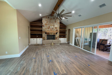 Inspiration for a mid-sized rustic brown floor and vaulted ceiling home gym remodel in Other