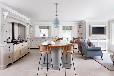 Inspiration for a large farmhouse l-shaped open plan kitchen in Belfast with a submerged sink, beaded cabinets, blue cabinets, quartz worktops, white splashback, ceramic splashback, integrated appliances, ceramic flooring, an island and grey floors.