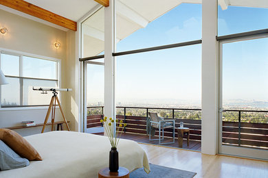 Inspiration for a contemporary bedroom in San Francisco with beige walls and light hardwood floors.