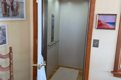 Example of a beach style light wood floor, beige floor and wood ceiling hallway design in Other with beige walls