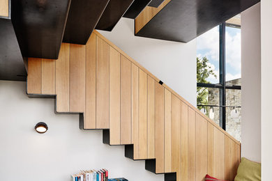Example of a large trendy floating wood railing staircase design in Austin
