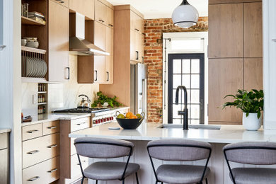 Example of a mid-sized transitional l-shaped dark wood floor and brown floor enclosed kitchen design in DC Metro with white backsplash, stainless steel appliances, a peninsula, white countertops, an undermount sink, flat-panel cabinets and light wood cabinets