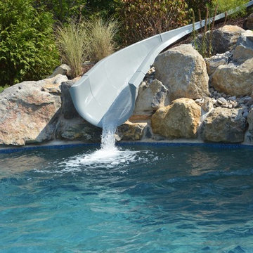 Custom Freeform style salt water in ground pool with Waterslide and Spa