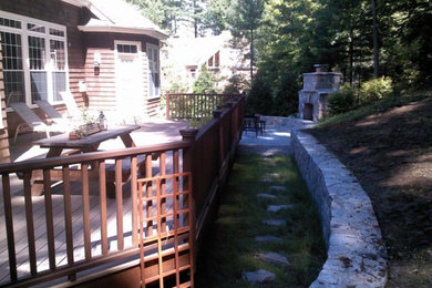 Inspiration for a large backyard stone patio remodel in New York with a fire pit and no cover