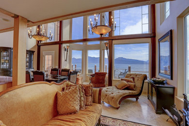 Example of a large classic open concept marble floor, beige floor and wood ceiling family room design in Other with a bar, beige walls, a stone fireplace and a media wall