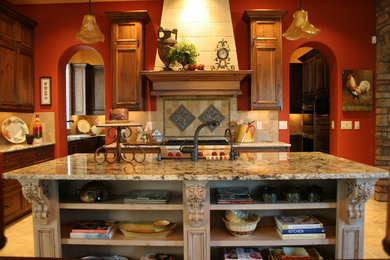 Inspiration for a mediterranean kitchen remodel in Boise with granite countertops, beige backsplash and an island