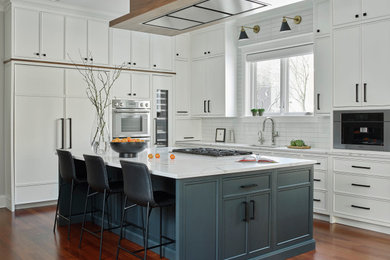 Inspiration for a transitional l-shaped dark wood floor and brown floor eat-in kitchen remodel in Chicago with white cabinets, white backsplash, porcelain backsplash, stainless steel appliances, an island, white countertops, quartzite countertops, an undermount sink and shaker cabinets
