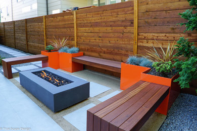 Inspiration for a mid-sized modern drought-tolerant and shade backyard concrete paver and wood fence landscaping in Seattle for summer.