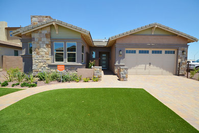Mid-sized one-storey blue exterior in Phoenix with stone veneer.