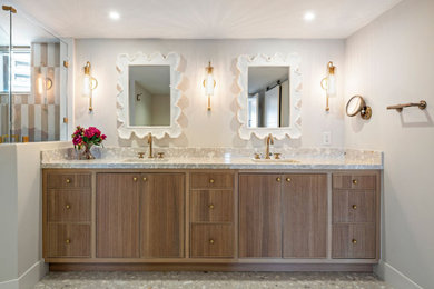Example of a beach style double-sink bathroom design in Miami with medium tone wood cabinets