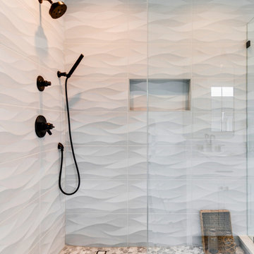 Textured Wave Tile Shower with Matte Black Fixtures and Pebble Floor