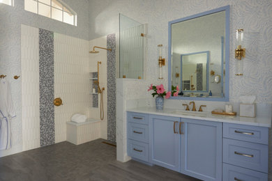 Design ideas for a large classic ensuite bathroom in Miami with shaker cabinets, blue cabinets, a built-in shower, a two-piece toilet, white tiles, ceramic tiles, blue walls, porcelain flooring, a submerged sink, engineered stone worktops, grey floors, an open shower, white worktops, a wall niche, double sinks, a built in vanity unit and wallpapered walls.
