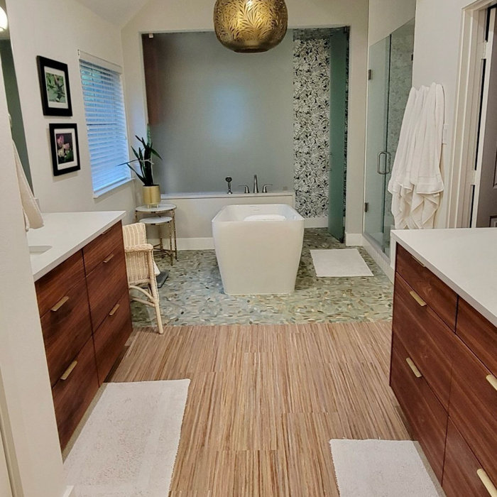 Home remodel is complete in PLANO. Updated and expanded the master bath with a toilet closet behind etched glass, pedestal tub, walk-in shower, custom wood vanity, wallpaper and custom flooring.