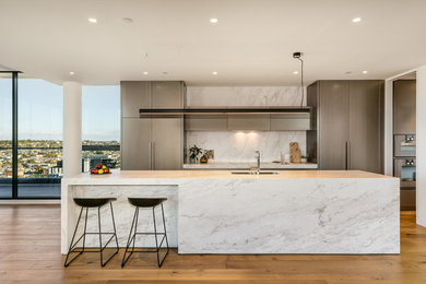 Design ideas for a mid-sized contemporary galley open plan kitchen in Melbourne with a double-bowl sink, grey cabinets, marble benchtops, multi-coloured splashback, marble splashback, stainless steel appliances and with island.