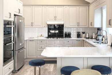 Example of a transitional kitchen design in Calgary