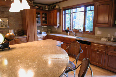 Example of a large transitional l-shaped light wood floor and beige floor eat-in kitchen design in Other with an undermount sink, raised-panel cabinets, medium tone wood cabinets, laminate countertops, brown backsplash, stone slab backsplash, stainless steel appliances and an island