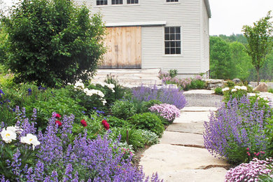 This is an example of a contemporary full sun stone landscaping in Portland Maine for summer.