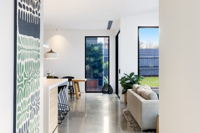 Design ideas for a contemporary hallway in Melbourne with white walls and concrete floors.