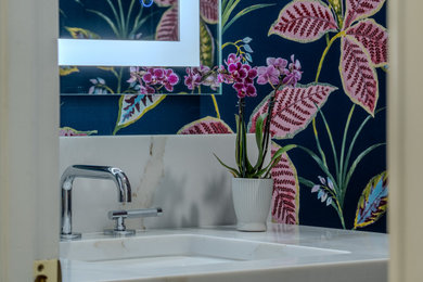 Inspiration for a mid-sized contemporary wallpaper powder room remodel in Miami with an undermount sink, quartz countertops, beige countertops and a built-in vanity