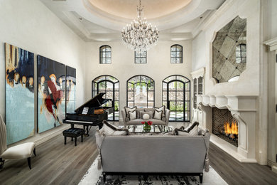 Inspiration for a huge french country formal and open concept medium tone wood floor, brown floor and vaulted ceiling living room remodel in Phoenix with beige walls, a standard fireplace, a stone fireplace and no tv