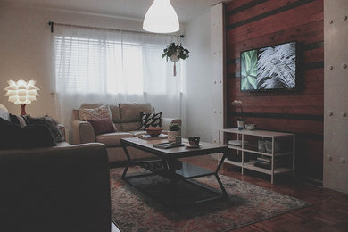 Inspiration for an industrial living room remodel in New York with white walls and a wall-mounted tv