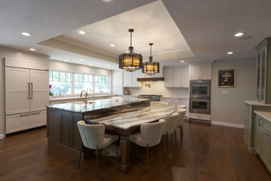 Example of a large classic eat-in kitchen design in St Louis with two islands