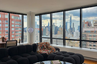 Living room - mid-sized 1960s open concept medium tone wood floor and orange floor living room idea in New York with white walls, no fireplace and a tv stand